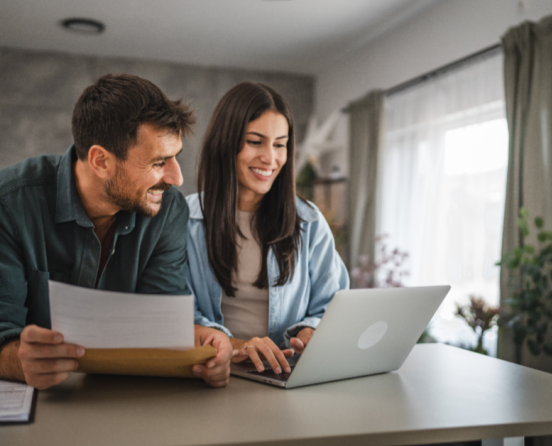 Couple reading DM with laptop -flip